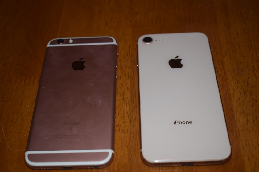 A photo depicting the back of each phone, one fully metallic and dusted with fingerprints (left) and one sleek and shiny with no fingerprints or debris (right) 