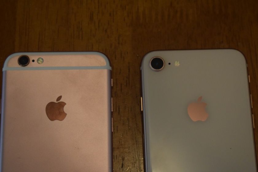 Close-up photo of the top of two phones side by side, shown from the back, to show difference in color